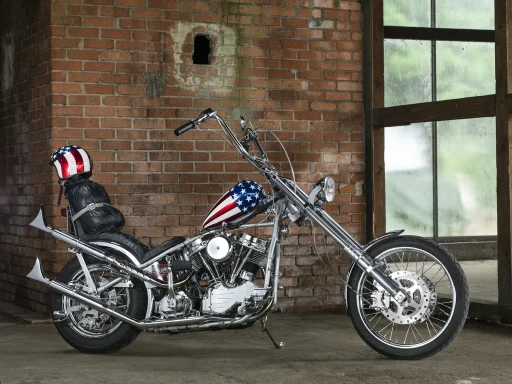 Harley-Davidson Panhead Captain America mit Stars-and-Stripes-Lackierung und langer Springergabel in einer Industriehalle.
